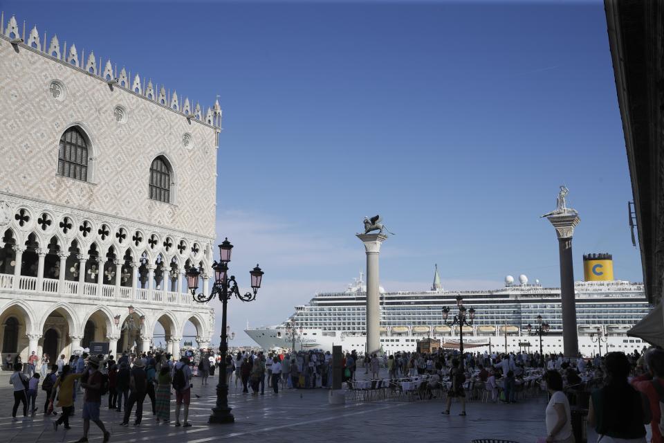 FILE- In this June 2, 2019 file photo, a cruise ship passes by St. Mark's Square in Venice, Italy. UNESCO’s World Heritage Committee is debating Thursday, July 22, 2021, whether Venice and its lagoon environment will be designated a world heritage site in danger due to the impact of over-tourism alongside the steady decline in population and poor governance. (AP Photo/Luca Bruno, file)