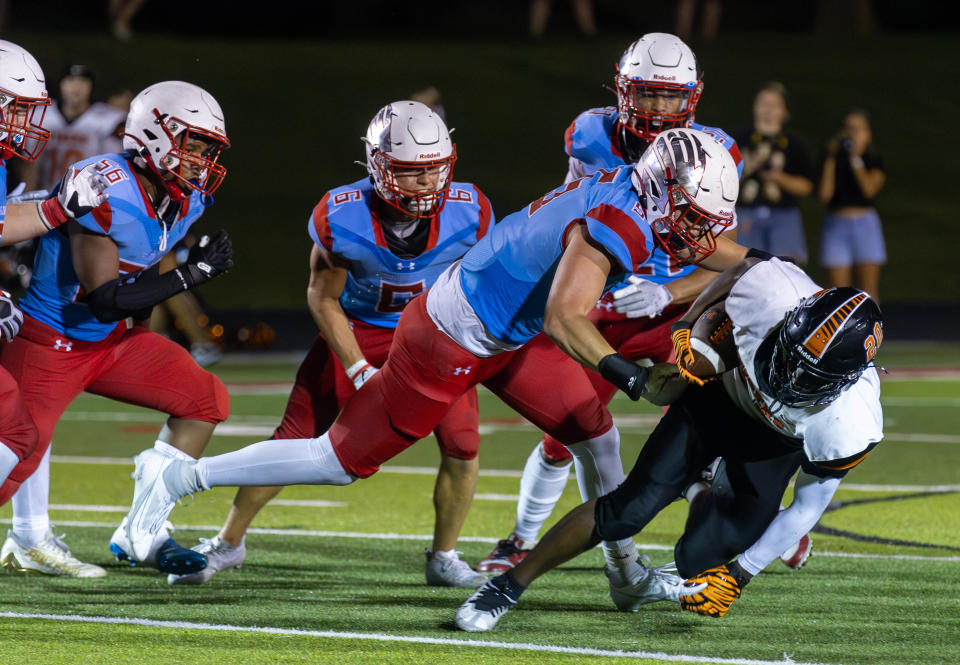 Waynesville’s Michael Kelsey Jr. is tackled by Glendale’s Kellen Lindstrom on August 25, 2023.