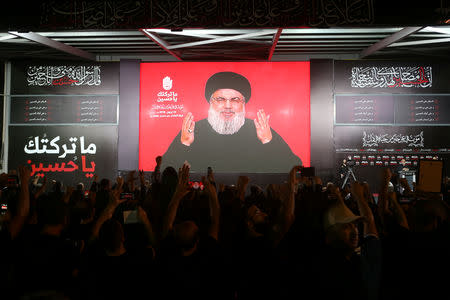 Lebanon's Hezbollah leader Sayyed Hassan Nasrallah gestures as he addresses his supporters via a screen the night before Muslim Shi'ites around the world mark the day of Ashura, in Beirut, Lebanon September 19, 2018. REUTERS/Hasan Shaaban