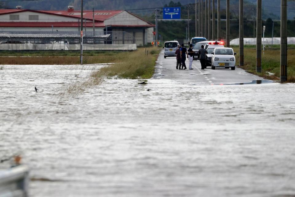 A road is submerged under water in Saito, Miyazaki prefecture in Japan on Monday (AP)