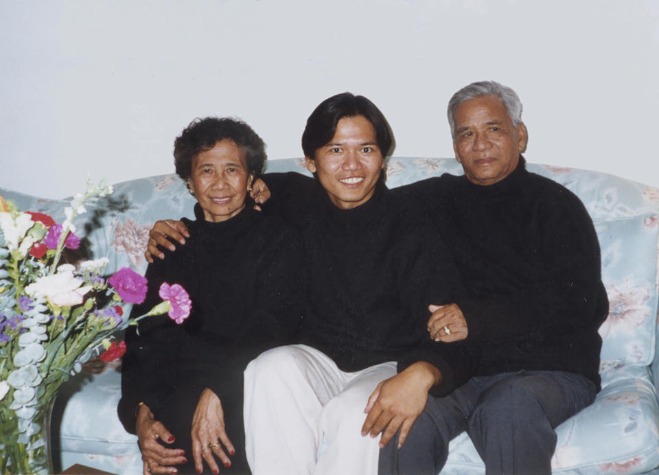 In this 1997 photo taken about a year before his father's death, Associated Press writer Bobby Calvan, center, poses with his mother and father, Erlinda and Florentino Calvan in Morgan Hill, Calif. (Courtesy Calvan Family via AP)