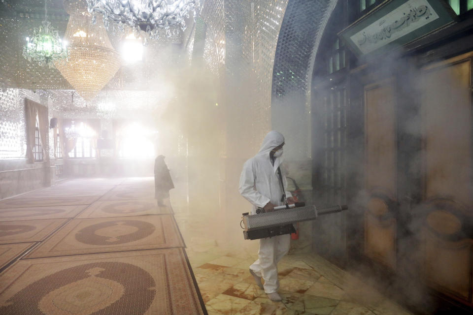 A firefighter disinfects the shrine of Saint Saleh to help prevent the spread of the new coronavirus in northern Tehran, Iran, Friday, March, 6, 2020.  A Health Ministry spokesman warned authorities could use unspecified “force” to halt travel between major cities.  (AP Photo/Ebrahim Noroozi)