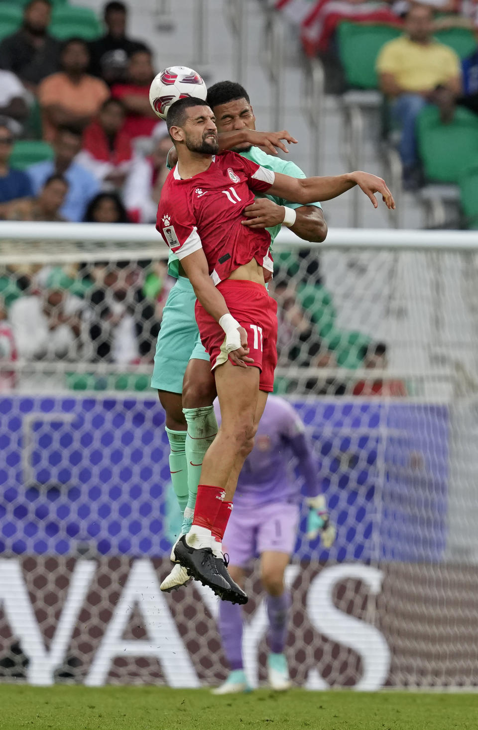 Lebanon's Omar Chaaban, front, and China's Jiang Guangtai reach for a header during the Asian Cup Group A soccer match between China and Lebanon at Al Thumama Stadium in Doha, Qatar, Wednesday, Jan. 17, 2024. (AP Photo/Thanassis Stavrakis)