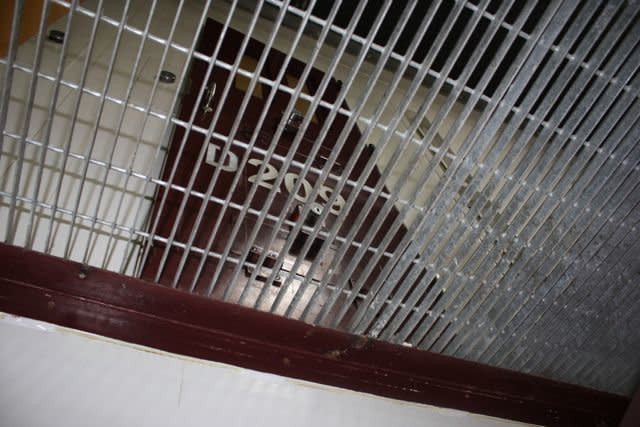 The second level of an empty cell block in Camp VI as seen from below.