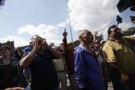 People shout against members of the LeBaron family and activist and poet Javier Sicilia during a march against violence called "Walk for Peace," in Mexico City, Sunday, Jan. 26, 2020. The march against violence was met by government supporters who yelled insults against the demonstrators and members of the press. (AP Photo/Ginnette Riquelme)