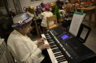 Conchita, 90 years old, a resident of the San Jeronimo nursing home, plays a keyboard during New Year's Eve celebrations in Estella, northern Spain, Thursday, Dec. 31, 2020. (AP Photo/Alvaro Barrientos)