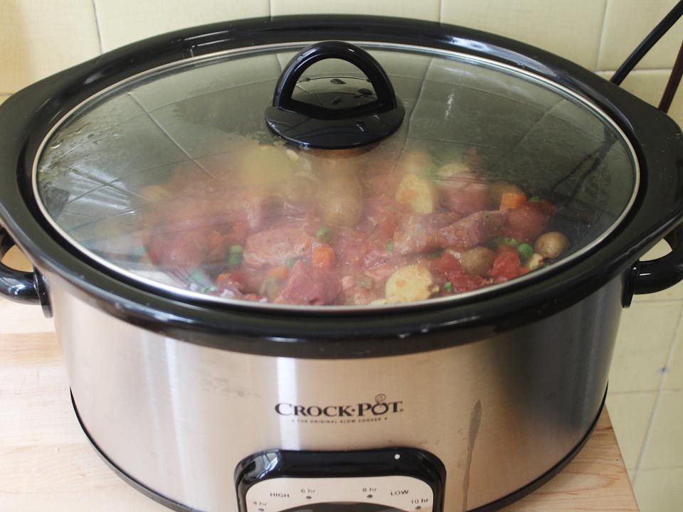 martha stewart recipe for beef stew in a silver crock pot with the lid on