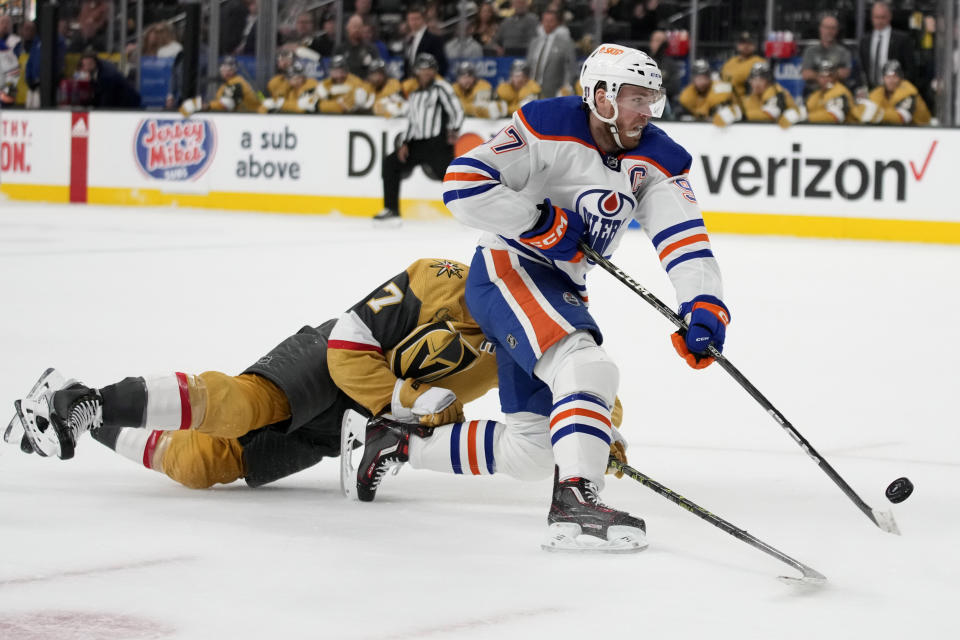 Edmonton Oilers center Connor McDavid (97) shoots around Vegas Golden Knights defenseman Alex Pietrangelo (7) during the first period of Game 2 of an NHL hockey Stanley Cup second-round playoff series Saturday, May 6, 2023, in Las Vegas. (AP Photo/John Locher)