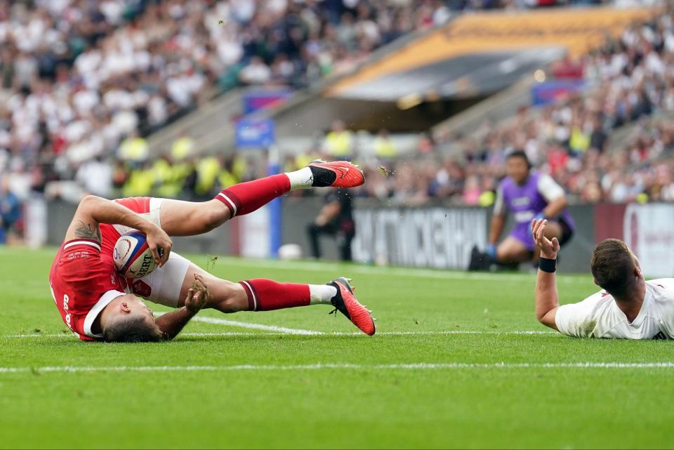 England's Freddie Steward tackles Wales' Josh Adams in the air (PA)