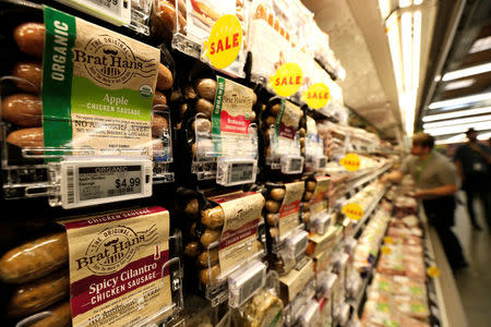 Prices of packaged sausages are displayed on digital price tags at a 365 by Whole Foods Market grocery store ahead of its opening day in Los Angeles, U.S., May 24, 2016. REUTERS/Mario Anzuoni