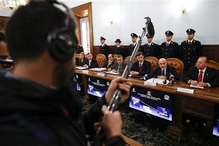 Director of the Italian S.C.O. (Central Operative System) Raffaele Grassi (2nd R) talks during a news conference with Italian and U.S. investigators in Rome February 11, 2014. REUTERS/Tony Gentile