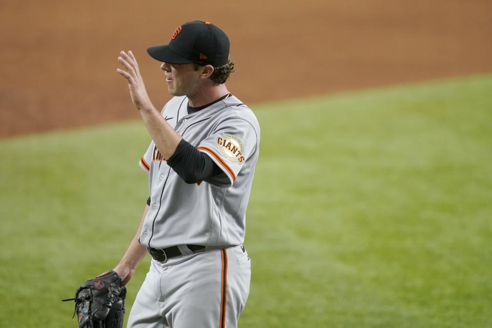 San Francisco Giants relief pitcher Sammy Long waves as he walks to the dugout after being pulled in the sixth inning of a baseball game in Arlington, Texas, Wednesday, June 9, 2021. Long made his major league debut in the game. (AP Photo/Tony Gutierrez)