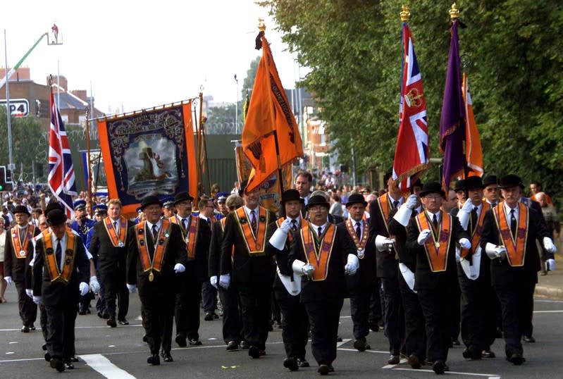 FILE PHOTO: Members of the Ballynafeigh Orange Lodge march away from the security barrier on the Ormeau Road, Belfast