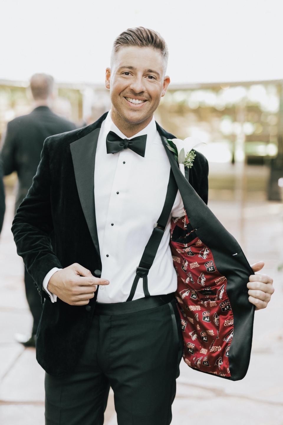 A groom shows off the printed inside of his jacket.