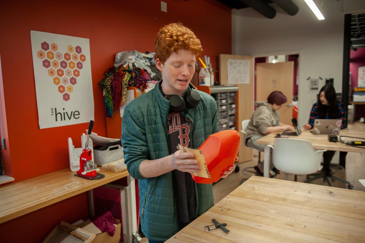 Jacob Edelman, a junior at New England Innovation Academy in Marlborough, sands the cone of his search-and-rescue airplane made from a 3D printer, April 30, 2024.