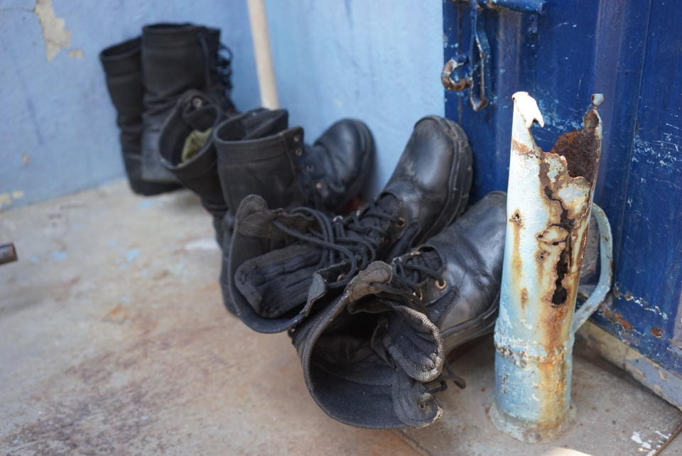 Boots belonging to defected members of Venezuela's National Guard sit out to dry where several dozen Venezuelan military defectors are sleeping at a shelter run by a priest in Cucuta, Colombia, Monday, Feb. 25, 2019. The simple house on a street ridden with potholes in this town on Colombia’s restive border with Venezuela has become a refuge for the newly homeless: 40 Venezuelan soldiers who abandoned their posts and ran for their lives. (AP Photo/Christine Armario)