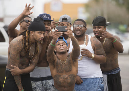 The group Stepp Chyld from Atlanta, Georgia, takes photos during spring break festivities in Panama City Beach, Florida March 12, 2015. REUTERS/Michael Spooneybarger