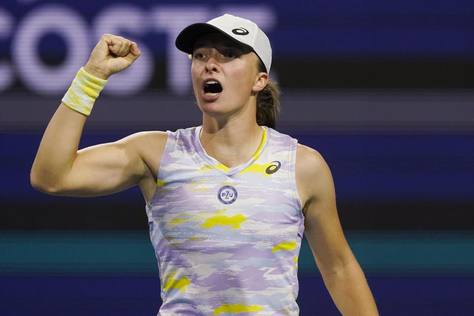 Iga Swiatek, of Poland, reacts after defeating Viktorija Golubic, of Switzerland, during the Miami Open tennis tournament Friday, March 25, 2022, in Miami Gardens, Fla. (AP Photo/Marta Lavandier)