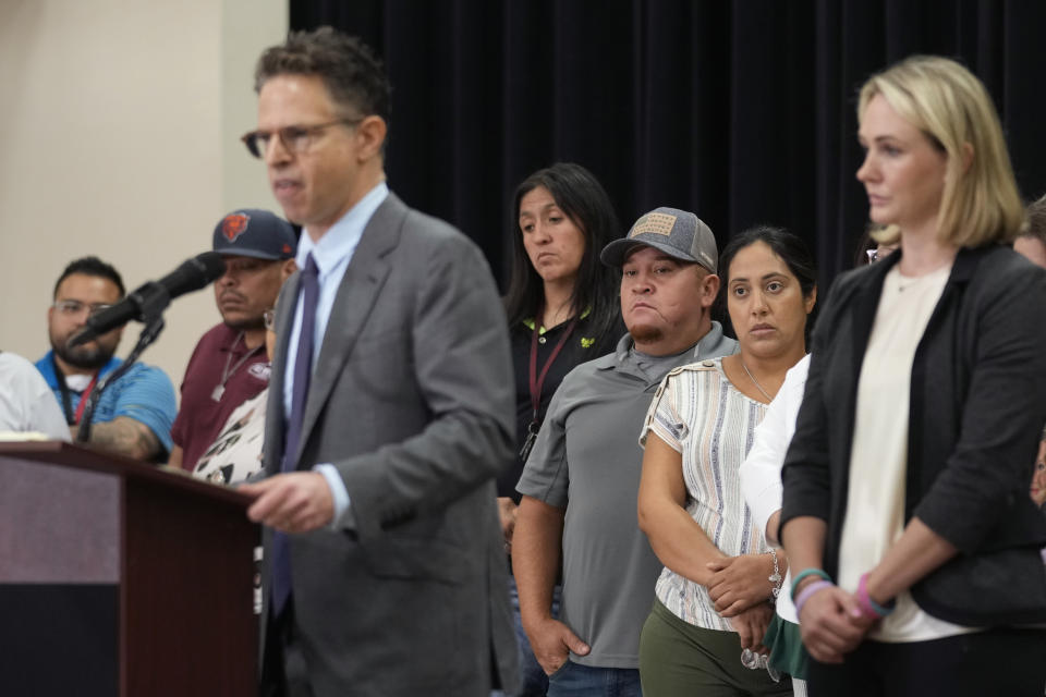 Families of the victims in the Uvalde elementary school shooting listen to attorney Josh Koskoff during a news conference, Wednesday, May 22, 2024, in Uvalde, Texas. The families of 19 of the victims announced a lawsuit against nearly 100 state police officers who were part of the botched law enforcement response. The families say they also agreed a $2 million settlement with the city, under which city leaders promised higher standards and better training for local police. (AP Photo/Eric Gay)