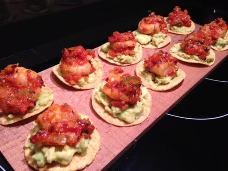 Tostadas with avocado, & shrimp ready to decorate with cilantro