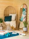 <p>AJ loves the calming nature of the summer house, especially the cosy 'wellness corner' where she's able to relax in the statement rattan balloon chair, which she says is her favourite piece of furniture. </p><p>A <a href="https://www.wayfair.co.uk/home-decor/pdp/brayden-studio-crewkerne-full-length-mirror-u000981097.html" rel="nofollow noopener" target="_blank" data-ylk="slk:full-length mirror;elm:context_link;itc:0;sec:content-canvas" class="link ">full-length mirror</a> leaning against the wall makes the space look bigger and brighter by reflecting the sunlight streaming in through the floor-to-ceiling windows. <br></p>