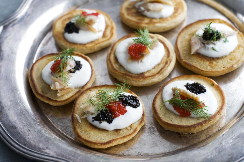 This Jan. 28, 2013 photo shows blini with smoked trout, caviar and horseradish cream served on a platter in Concord, N.H. These elegant hors d'oeuvres are perfect for an Oscar night viewing party. (AP Photo/Matthew Mead)