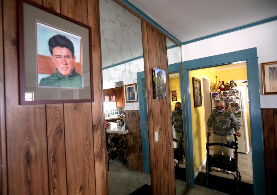 Ruth Soto stands in her home, with a photo of Jacob Cruz on a wall