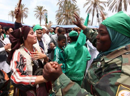 In this pictured, takend on a government guided tour, Libyans dance at Mitiga International airport in Tripoli, to celebrate 41 years after the United States turned Wheelus Air Base over to Libya and left in 1970. Turkey said it has offered Moamer Kadhafi guarantees to leave Libya but has yet to receive a reply, as rebels on Saturday accused his forces of shelling a UNESCO world heritage site