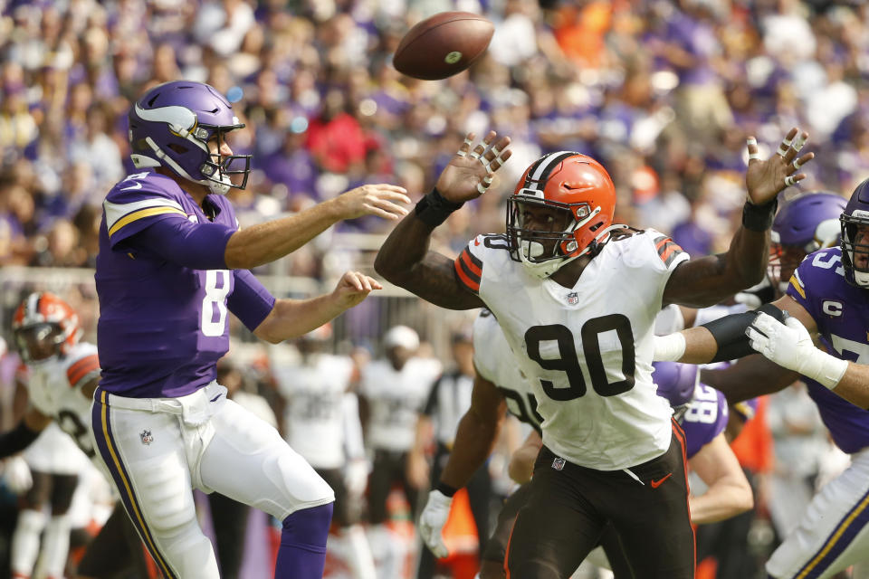 Cleveland Browns defensive end Jadeveon Clowney (90) pressures Minnesota Vikings quarterback Kirk Cousins (8) as he throws a pass during the first half of an NFL football game, Sunday, Oct. 3, 2021, in Minneapolis. (AP Photo/Bruce Kluckhohn)