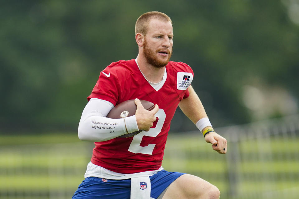 Indianapolis Colts quarterback Carson Wentz runs a drill during practice at the NFL team's football training camp in Westfield, Ind., Wednesday, July 28, 2021. (AP Photo/Michael Conroy)