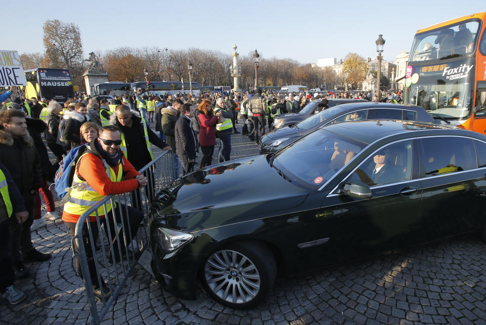 Protesters shout bloc the traffic on the place de la Concorde to protest fuel taxes in Paris, France, Saturday, Nov. 17, 2018. France is bracing for a nationwide traffic mess as drivers plan to block roads to protest rising fuel taxes, in a new challenge to embattled President Emmanuel Macron. (AP Photo/Michel Euler)