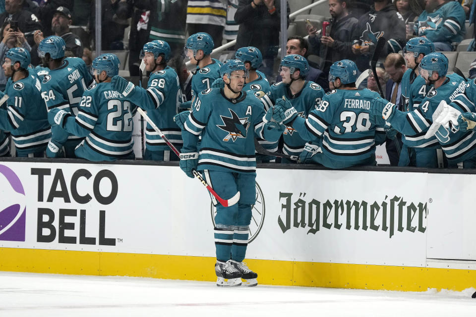 San Jose Sharks center Tomas Hertl (48) is congratulated by teammates after scoring a goal against the Edmonton Oilers during the second period of an NHL hockey game Thursday, Nov. 9, 2023, in San Jose, Calif. (AP Photo/Tony Avelar)