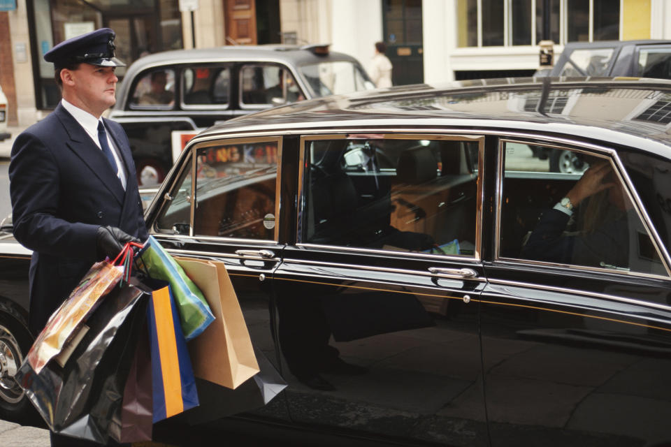 chauffeur holding shopping bags