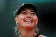 PARIS, FRANCE - JUNE 09: Maria Sharapova of Russia smiles as she celebrates victory in the women's singles final against Sara Errani of Italy during day 14 of the French Open at Roland Garros on June 9, 2012 in Paris, France. (Photo by Mike Hewitt/Getty Images)