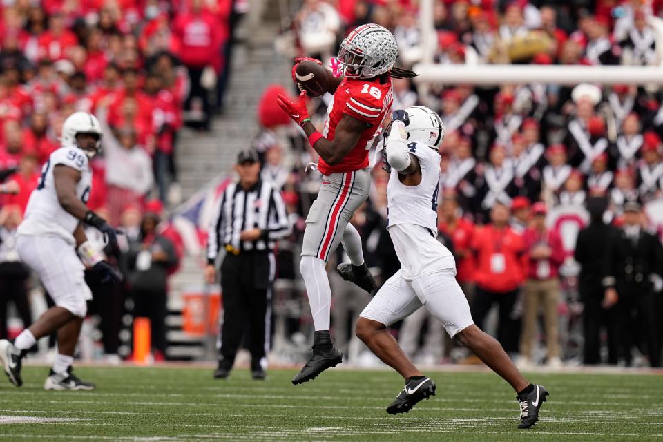 Oct 21, 2023; Columbus, Ohio, USA; Ohio State Buckeyes wide receiver Marvin Harrison Jr. (18) catches a pass in front of Penn State Nittany Lions cornerback Kalen King (4) during the second half of the NCAA football game at Ohio Stadium. Ohio State won 20-12.