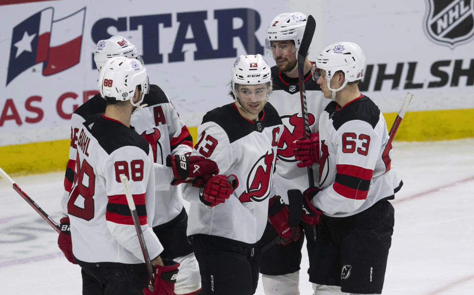 New Jersey Devils center Nico Hischier (13) celebrates with teammates after his goal during second-period NHL hockey game action against the Ottawa Senators in Ottawa, Ontario, Saturday, April 6, 2024. (Adrian Wyld/The Canadian Press via AP)