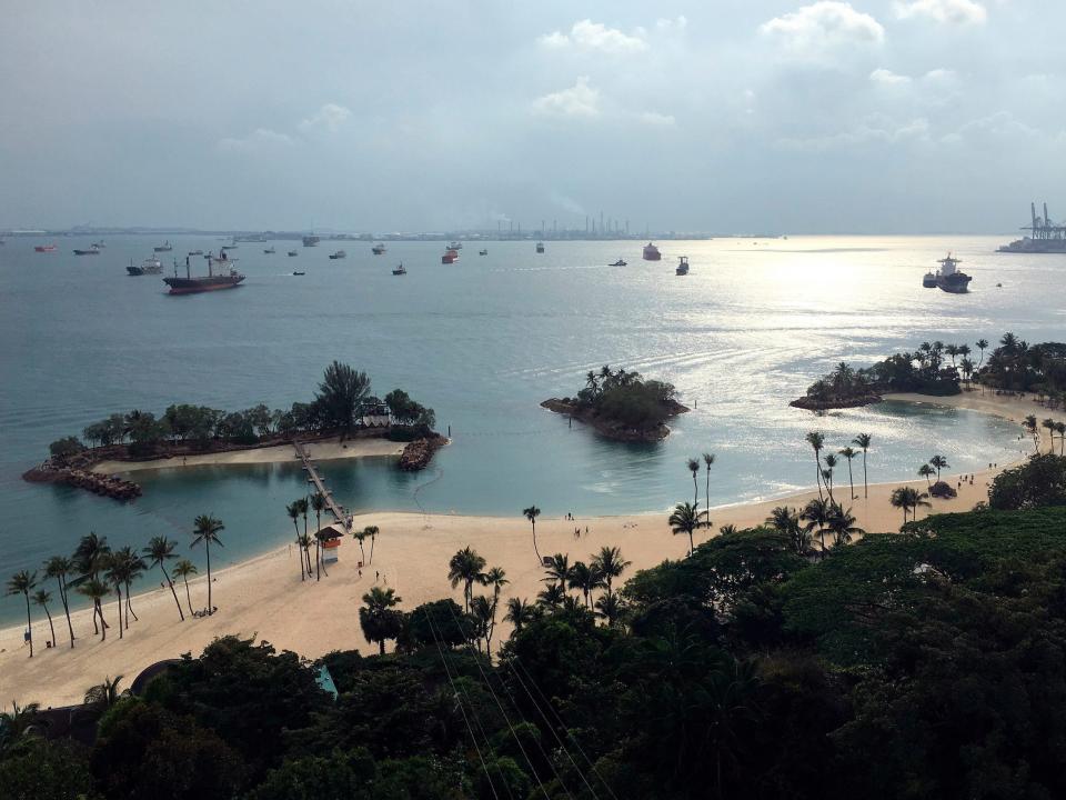 In this Feb. 25, 2018, photo, ships are anchored off Sentosa Island in Singapore.