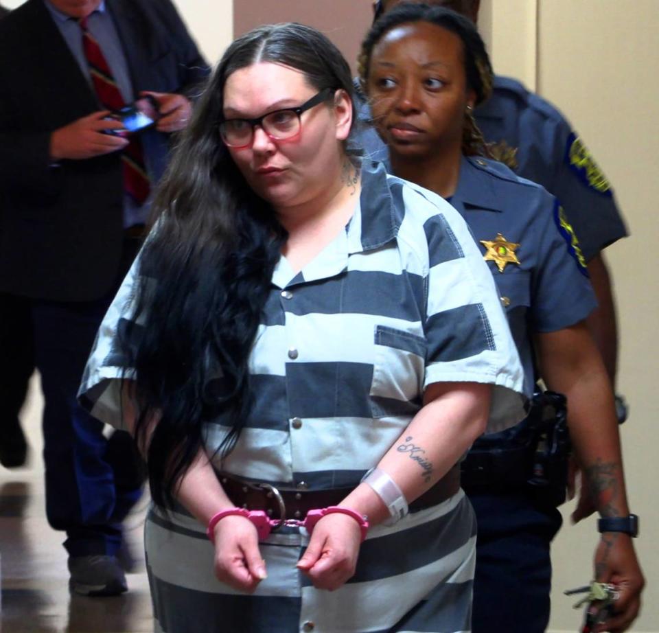 Kristy Marie Siple, center, is escorted to a courtroom Wednesday afternoon for a hearing before Circuit Court Judge David Johnson at the Russell County Courthouse in Phenix City, Alabama. 03/13/2024