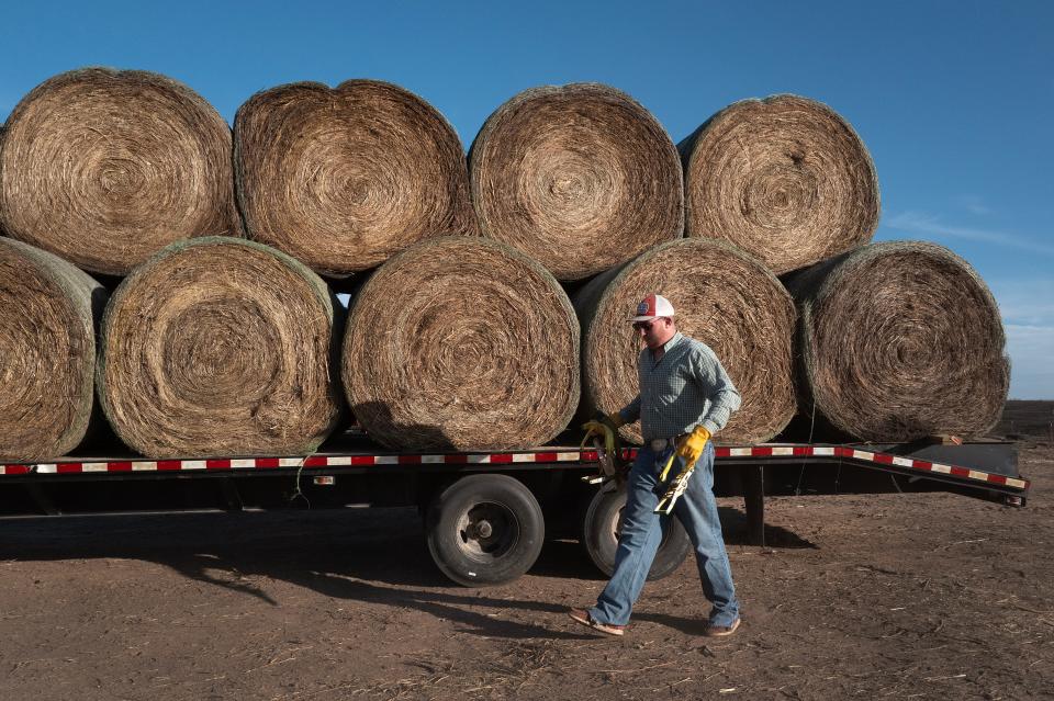 Thomas Drennan prepares to unload donated hay which he trucked 7 1/2 hours from Alvardo, Texas, to help victims of the Smokehouse Creek fire on March 5, 2024 in Canadian, Texas.