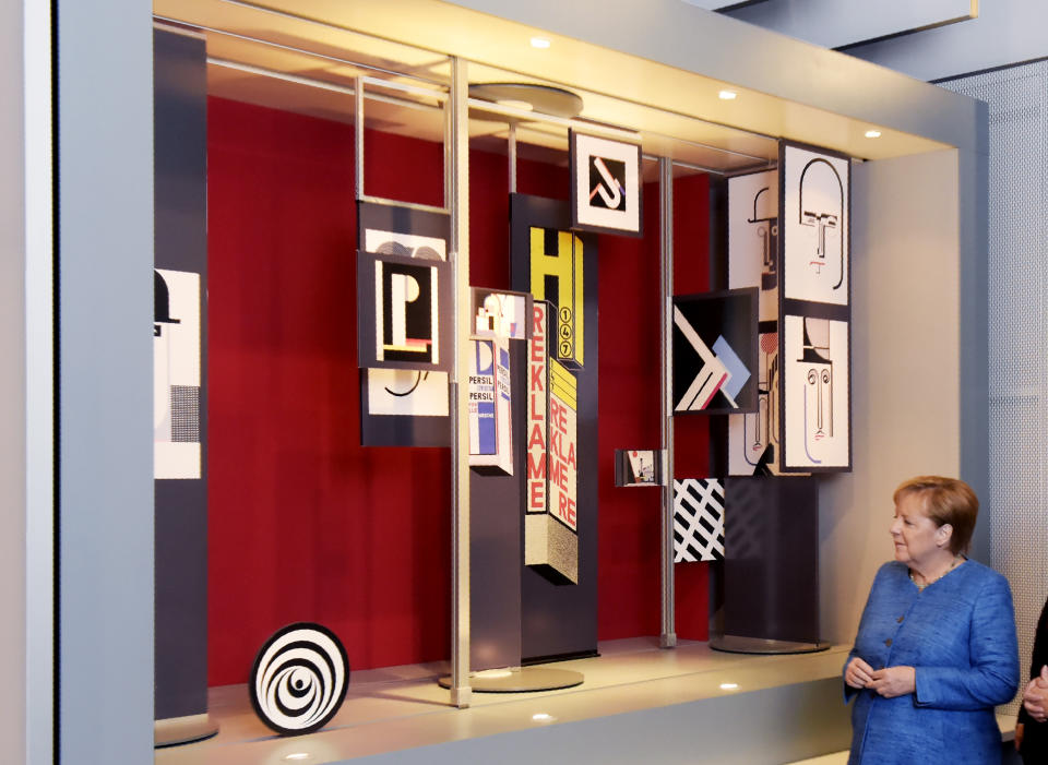 German Chancellor Angela Merkel looks at an installation during the official opening of the new Bauhaus Museum, built for the centenary of the founding of the Bauhaus, in Dessau, Germany Sunday, Sept. 8, 2019. (AP Photo/Jens Meyer)