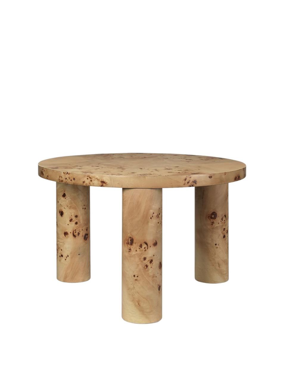 a burr wood coffee table with three legs
