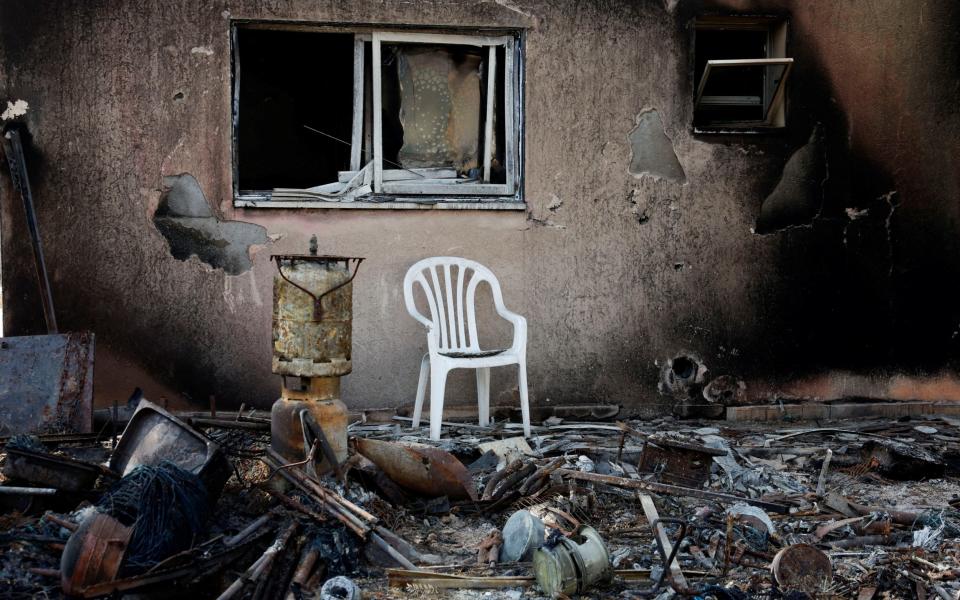 A destroyed home riddled with bullets