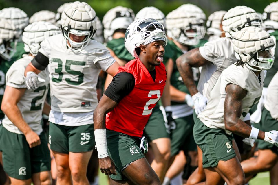 Michigan State quarterback Aidan Chiles runs with the team during the first day of football camp on Tuesday, July 30, 2024, in East Lansing.