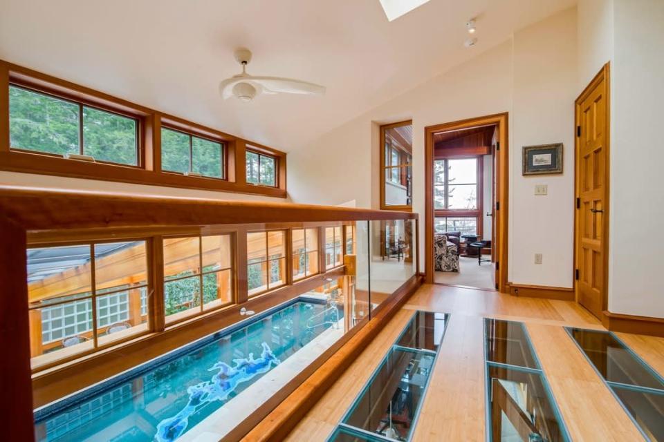 A view of the pool from a glass-bottomed hallway above