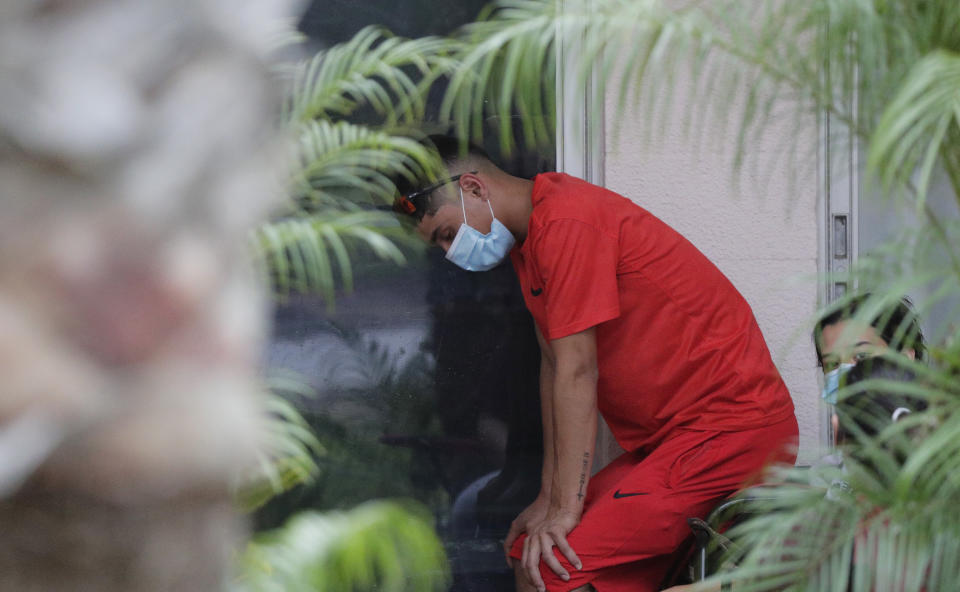 Family members wait near the window of a man with COVID-19 at Starr County Memorial Hospital, Tuesday, July 28, 2020, in Rio Grande City, Texas. (AP Photo/Eric Gay)