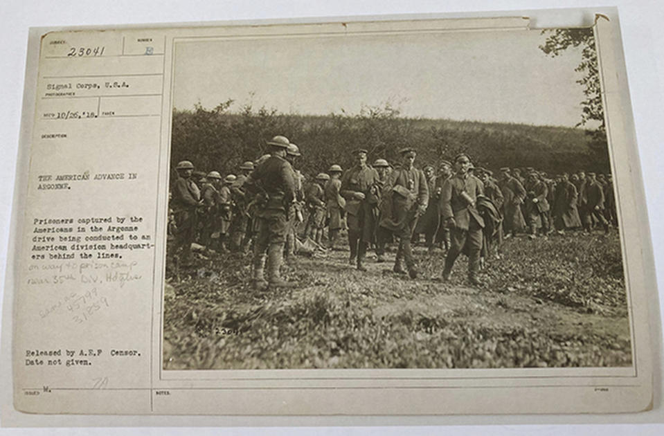 This photo provided by the U.S. Army Heritage and Education Center that shows American soldiers with German prisoners in northern France during WWI on Sept. 26, 1918 is shown attached to a sheet with historical information of the image. The claim in Pennsylvania state Sen. Doug Mastriano's 2014 book about Sgt. York, that this U.S. Army Signal Corps photo was mislabeled and actually shows Alvin C. York with three German officers he captured, has been disputed by rival researchers. (U.S. Army's signal corps via AP)