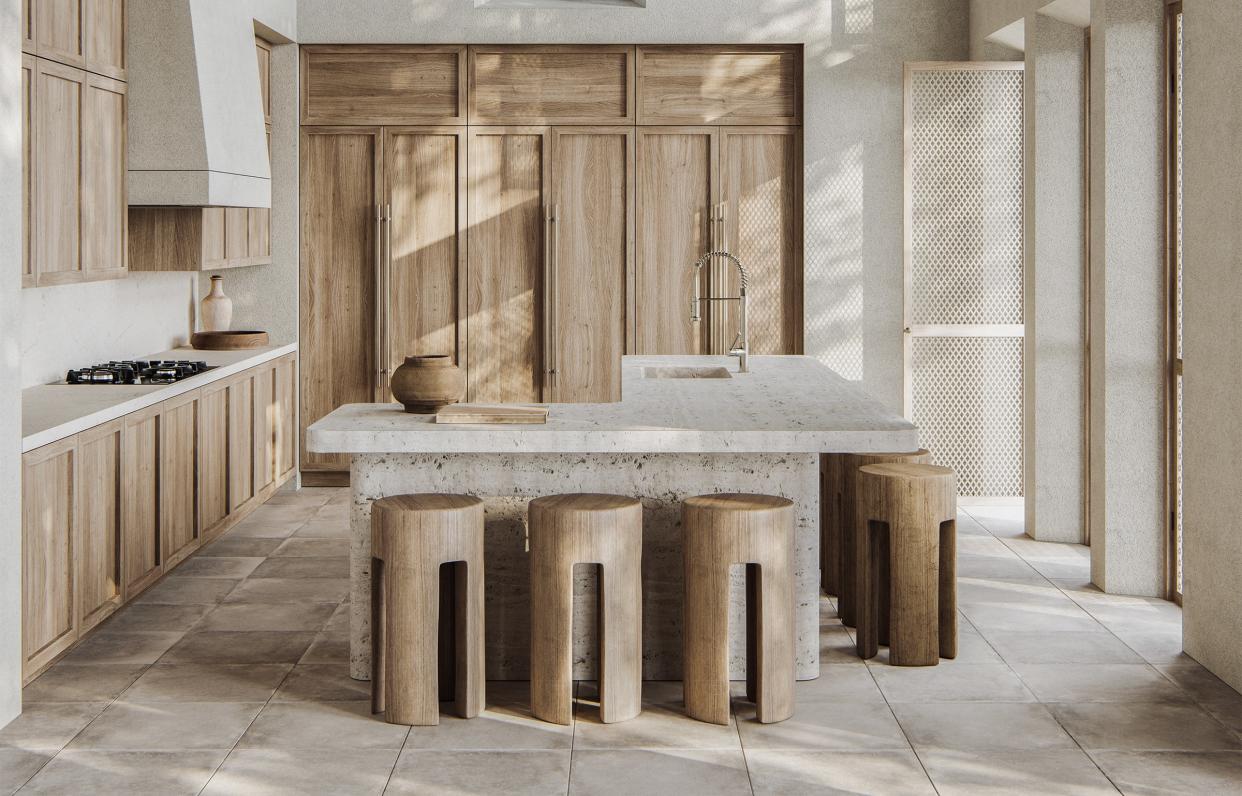  A kitchen with a marble countertop, and wooden cabinets and stools. 