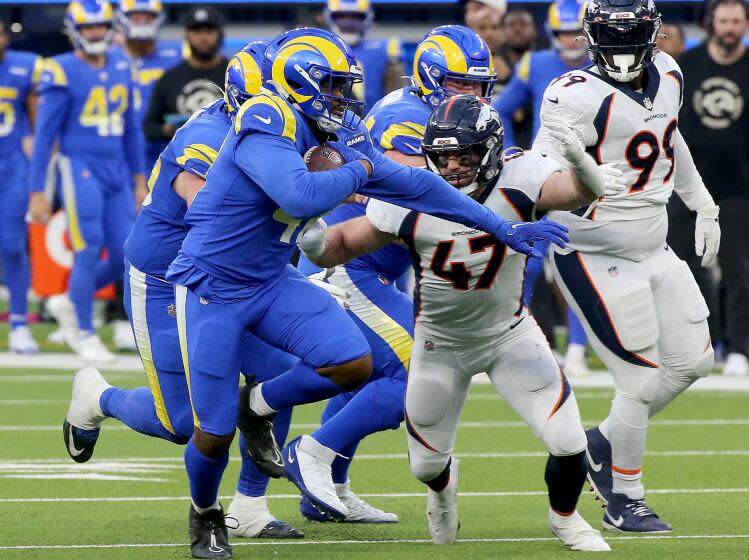 INGLEWOOD, CALIF. - DEC. 25, 2022. Rams running back Malcolm Brown get a big gain against the Broncos in the fourth quarter at SoFi Stadium in Inglewood on Sunday, Dec. 25, 2022. (Luis Sinco / Los Angeles Times)