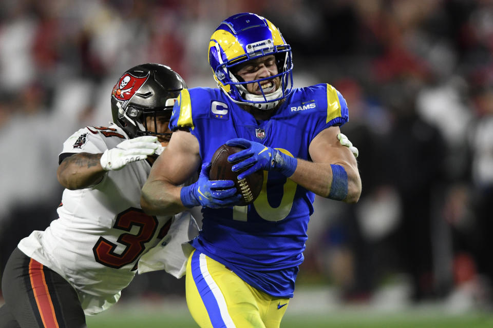 Los Angeles Rams wide receiver Cooper Kupp (10) is stopped by Tampa Bay Buccaneers safety Antoine Winfield Jr. (31) after a catch during the second half of an NFL divisional round playoff football game Sunday, Jan. 23, 2022, in Tampa, Fla. (AP Photo/Jason Behnken)