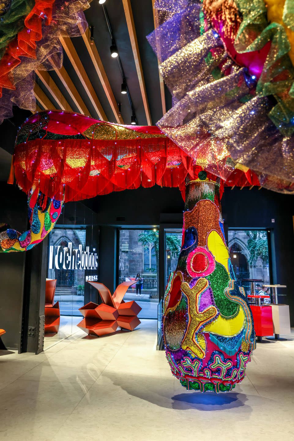 a colorful sculpture in front of a store